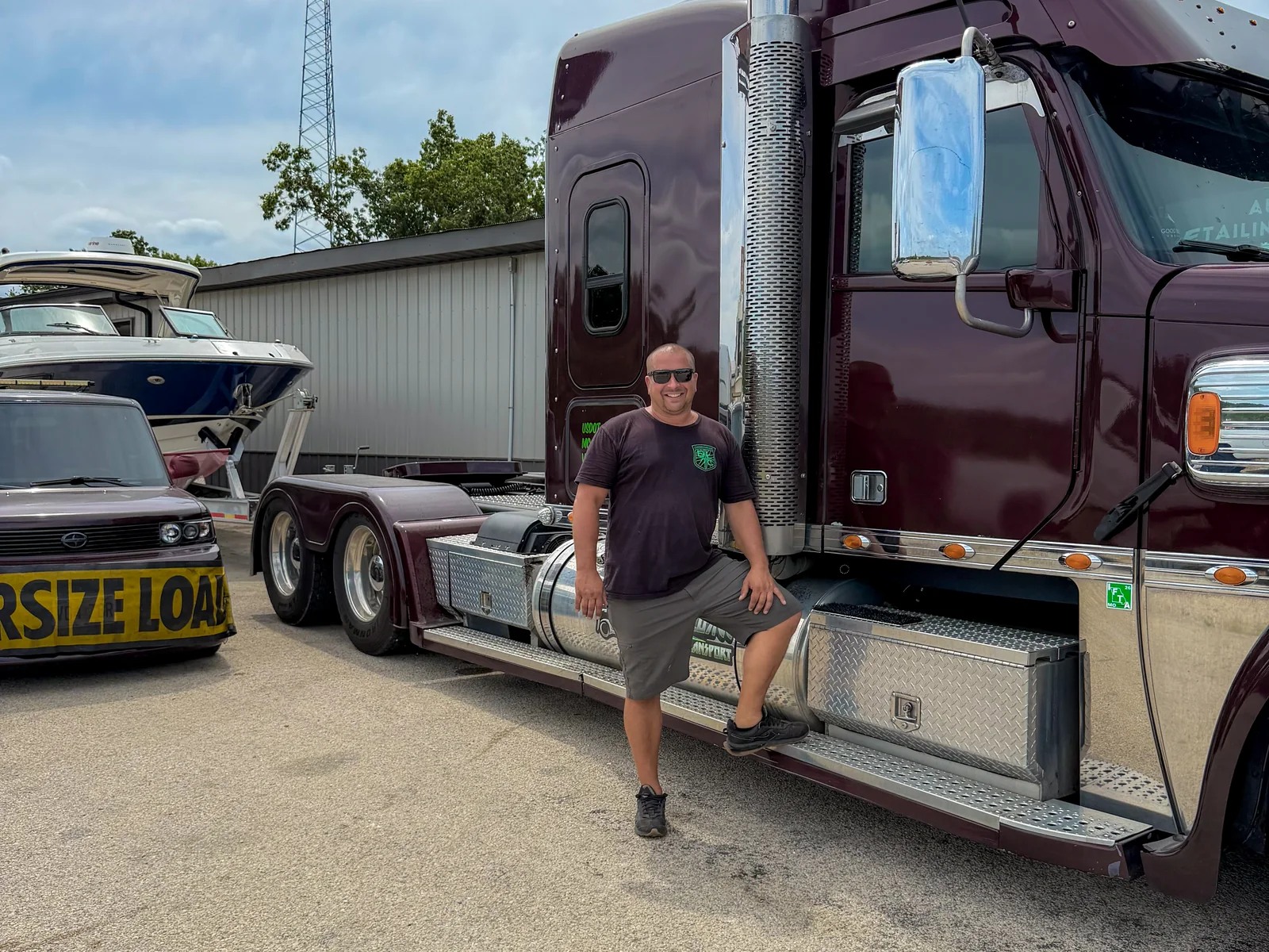 Aaron, owner and driver of Xclusive Transport Services, with his
           Freightliner Coronado and pilot car in Eldon, Missouri