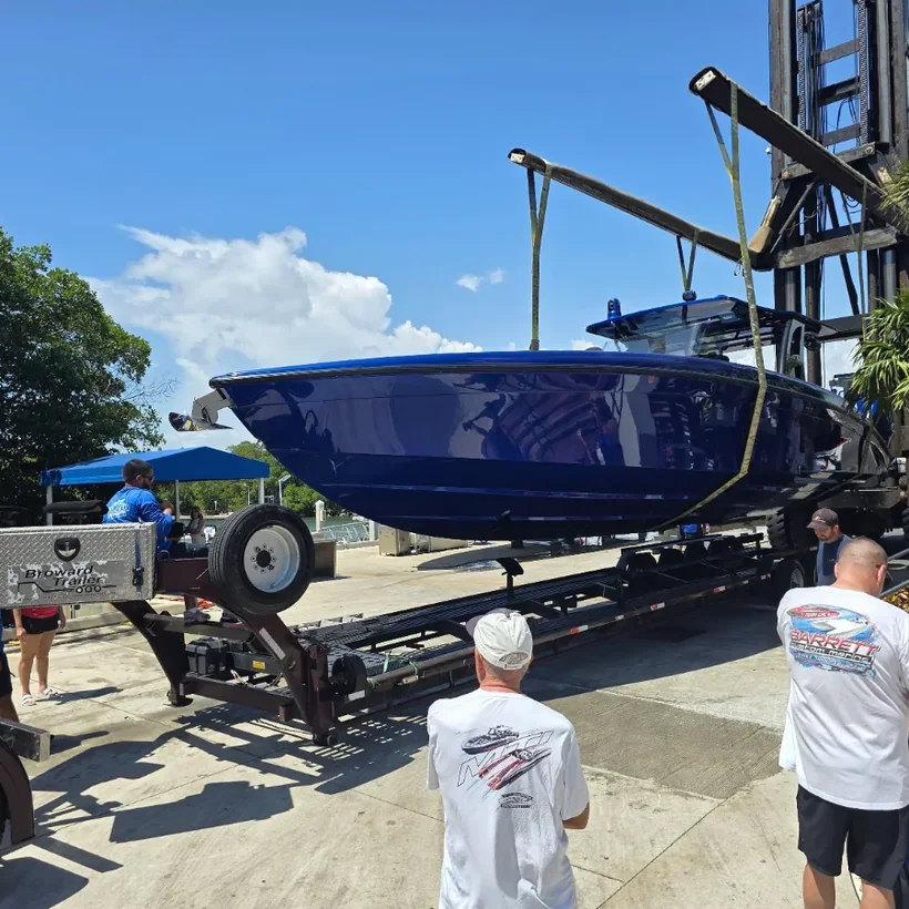 Performance boat being lifted onto a trailer at a Florida marina