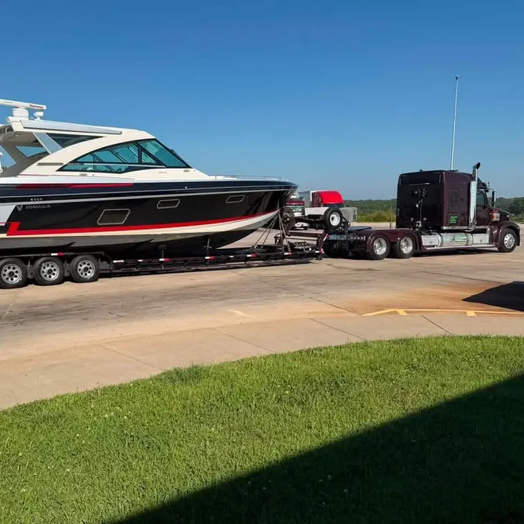 Large boat secured on a lowboy trailer ready for an over the road haul